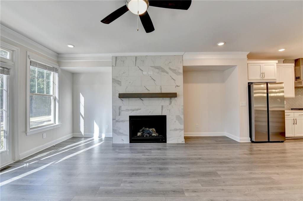3159 Clairebrooke Avenue Atlanta, GA 30341 - Photo 13 of 36 a view of an empty room with wooden floor fireplace and a window
