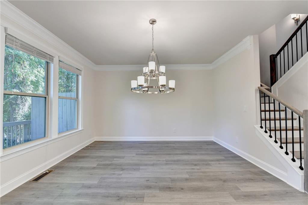 3159 Clairebrooke Avenue Atlanta, GA 30341 - Photo 14 of 36 a view of a room with wooden floor chandelier and windows
