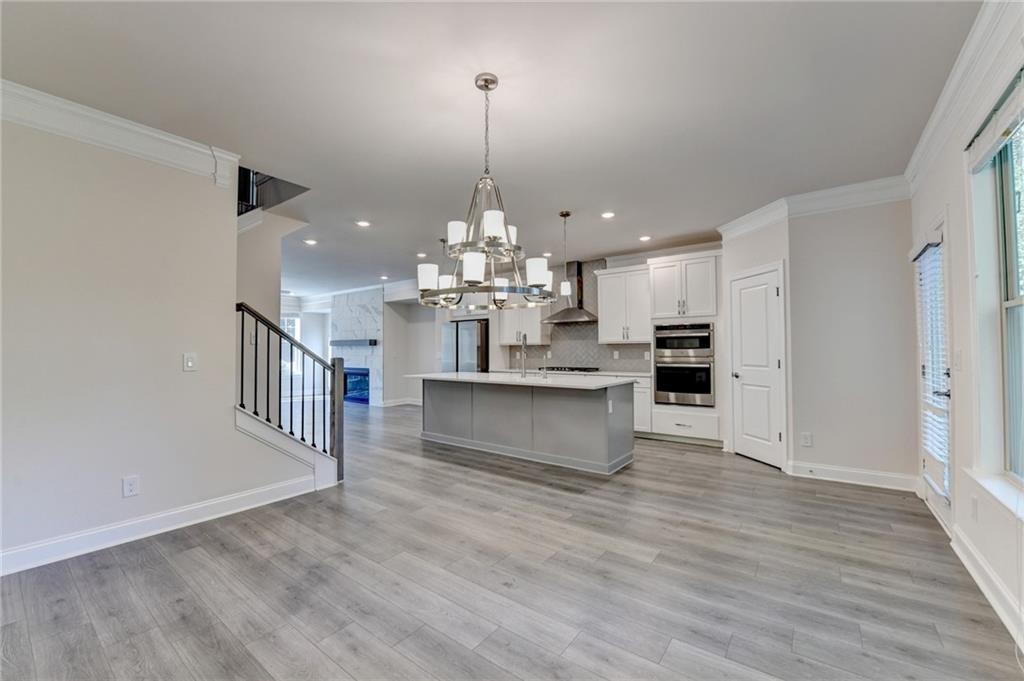 3159 Clairebrooke Avenue Atlanta, GA 30341 - Photo 16 of 36 a view of kitchen and kitchen with a sink wooden floor and chandelier