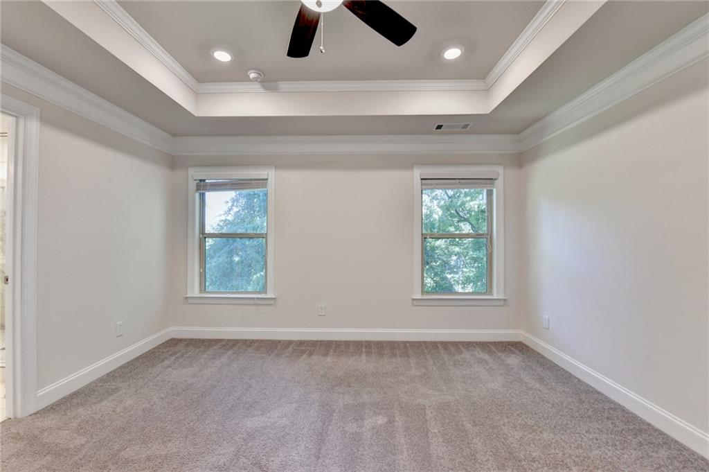 3159 Clairebrooke Avenue Atlanta, GA 30341 - Photo 20 of 36 an empty room with windows and ceiling fan