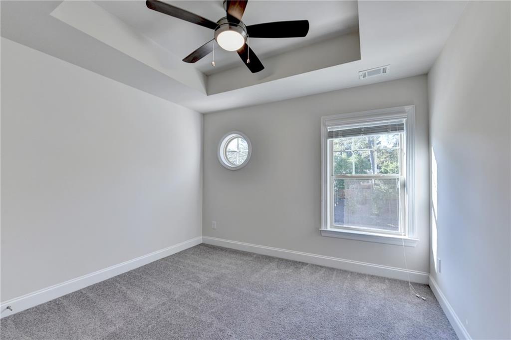 3159 Clairebrooke Avenue Atlanta, GA 30341 - Photo 24 of 36 an empty room with windows and fan