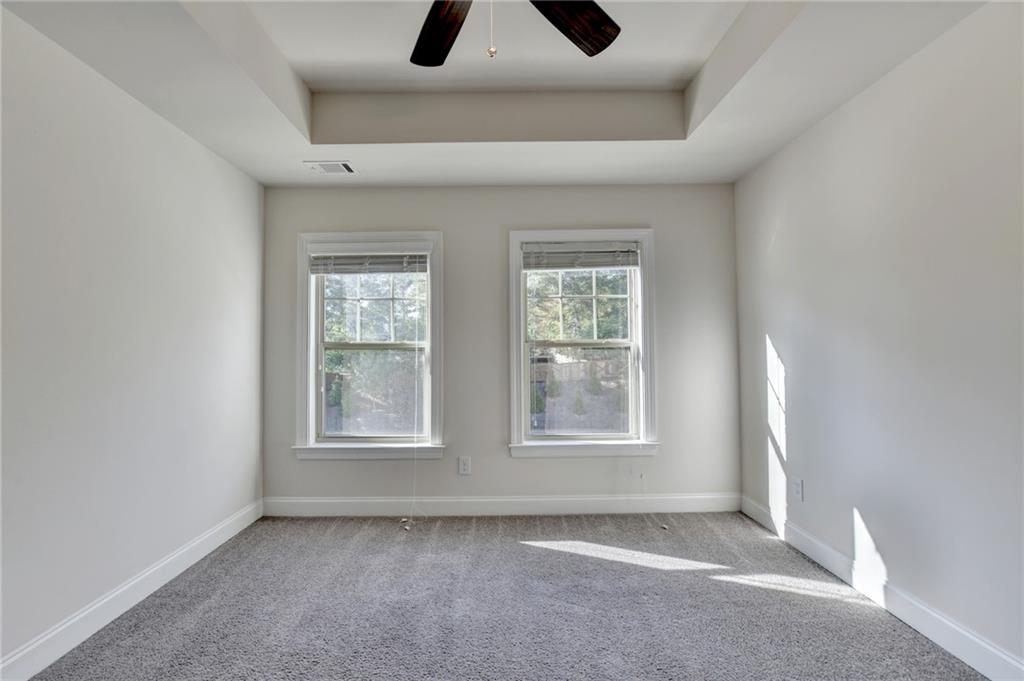 3159 Clairebrooke Avenue Atlanta, GA 30341 - Photo 26 of 36 an empty room with windows and fan