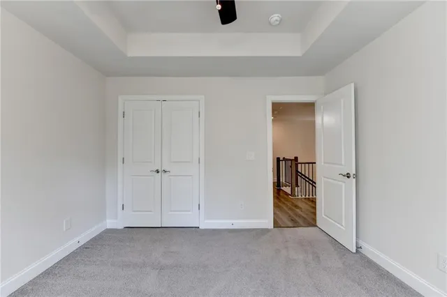 an empty room with closet and wooden floor