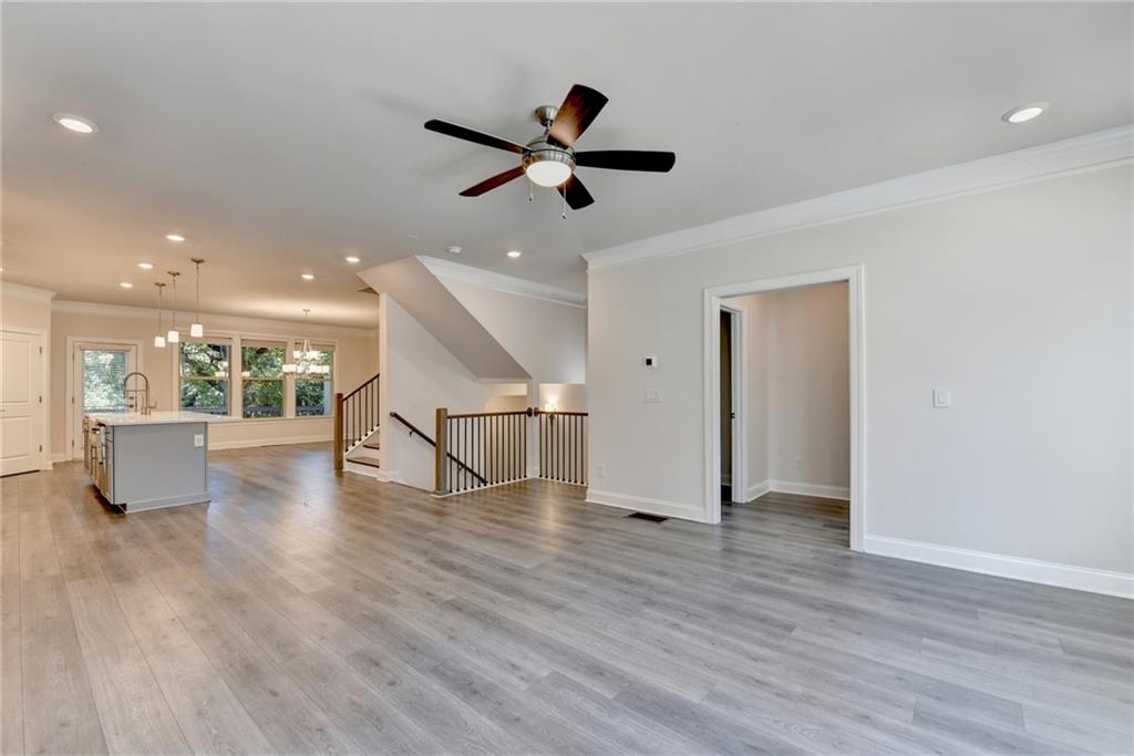 3159 Clairebrooke Avenue Atlanta, GA 30341 - Photo 3 of 36 a view of an empty room with wooden floor and a ceiling fan