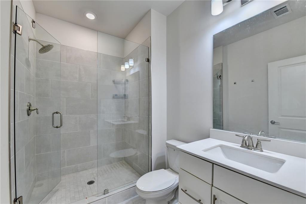 3159 Clairebrooke Avenue Atlanta, GA 30341 - Photo 31 of 36 a bathroom with a sink toilet a mirror and shower