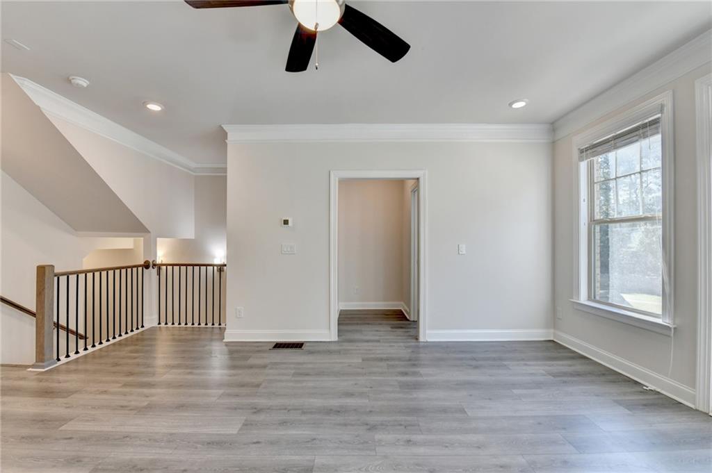 3159 Clairebrooke Avenue Atlanta, GA 30341 - Photo 4 of 36 a view of an empty room with wooden floor and window