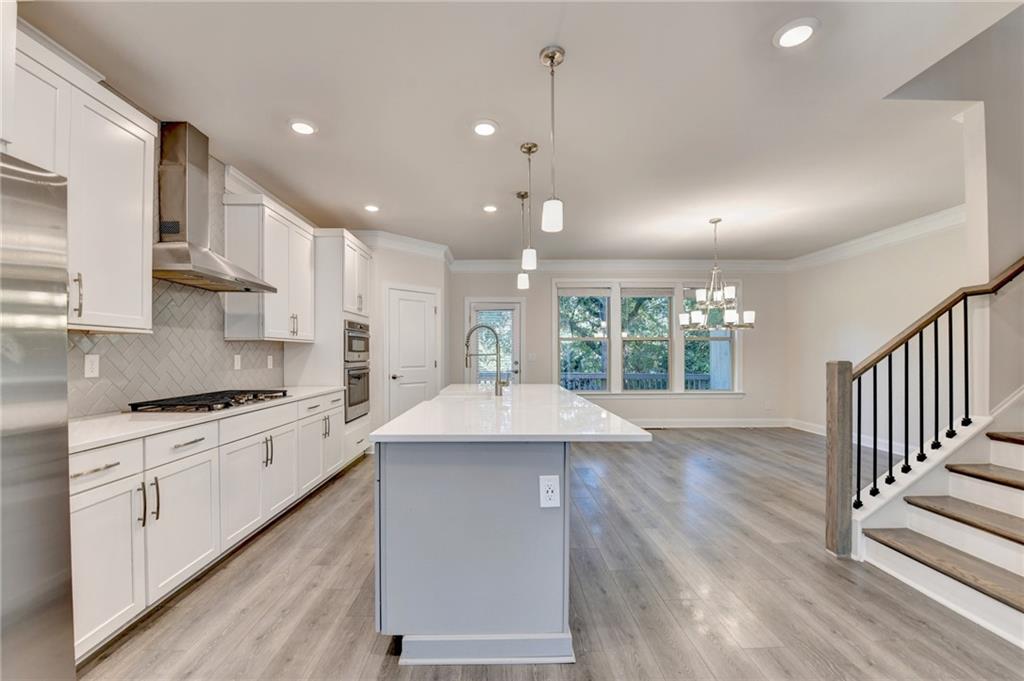 3159 Clairebrooke Avenue Atlanta, GA 30341 - Photo 5 of 36 a kitchen with kitchen island a sink and a stove top oven
