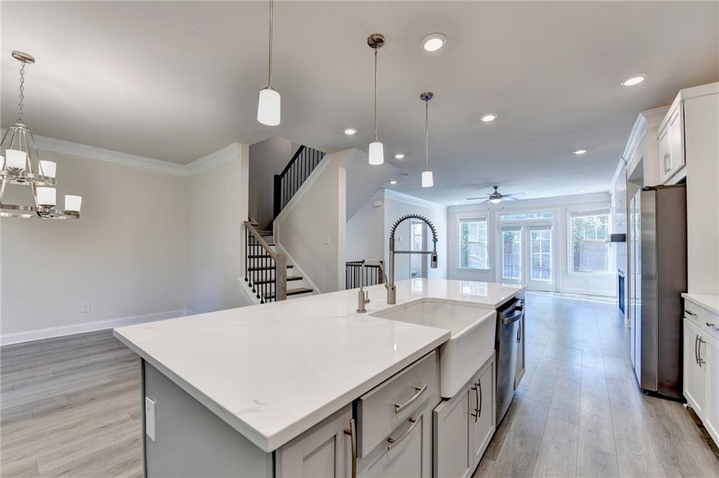 3159 Clairebrooke Avenue Atlanta, GA 30341 - Photo 10 of 36 a large kitchen with sink a refrigerator and chairs