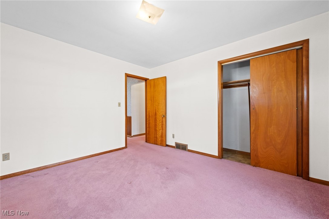586 Bishop Road Cleveland, OH 44143 - Photo 10 of 24 Unfurnished bedroom with carpet floors, a closet, visible vents, and baseboards