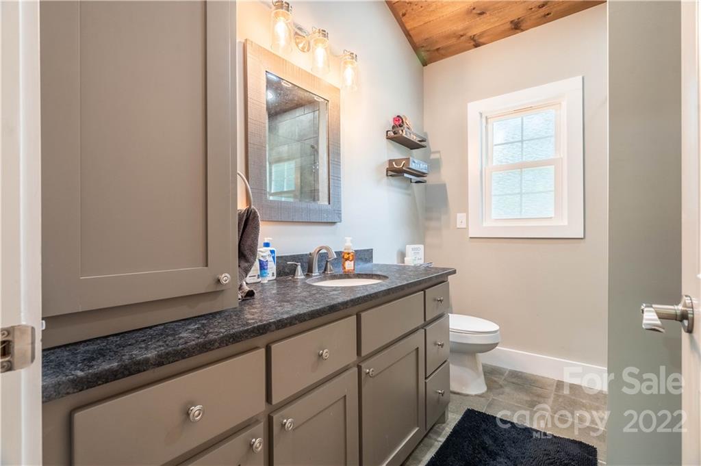 53 Forest Avenue Granite Falls, NC 28630 - Photo 15 of 37 a bathroom with a granite countertop sink mirror and toilet