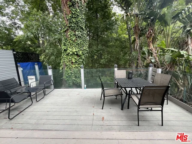 a view of a backyard with sitting area
