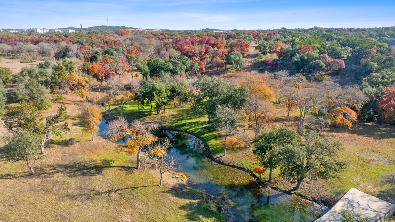 801 Needham Road Dripping Springs, TX 78620 - Photo 1 of 36 Aerial overview of property's location featuring a large body of water