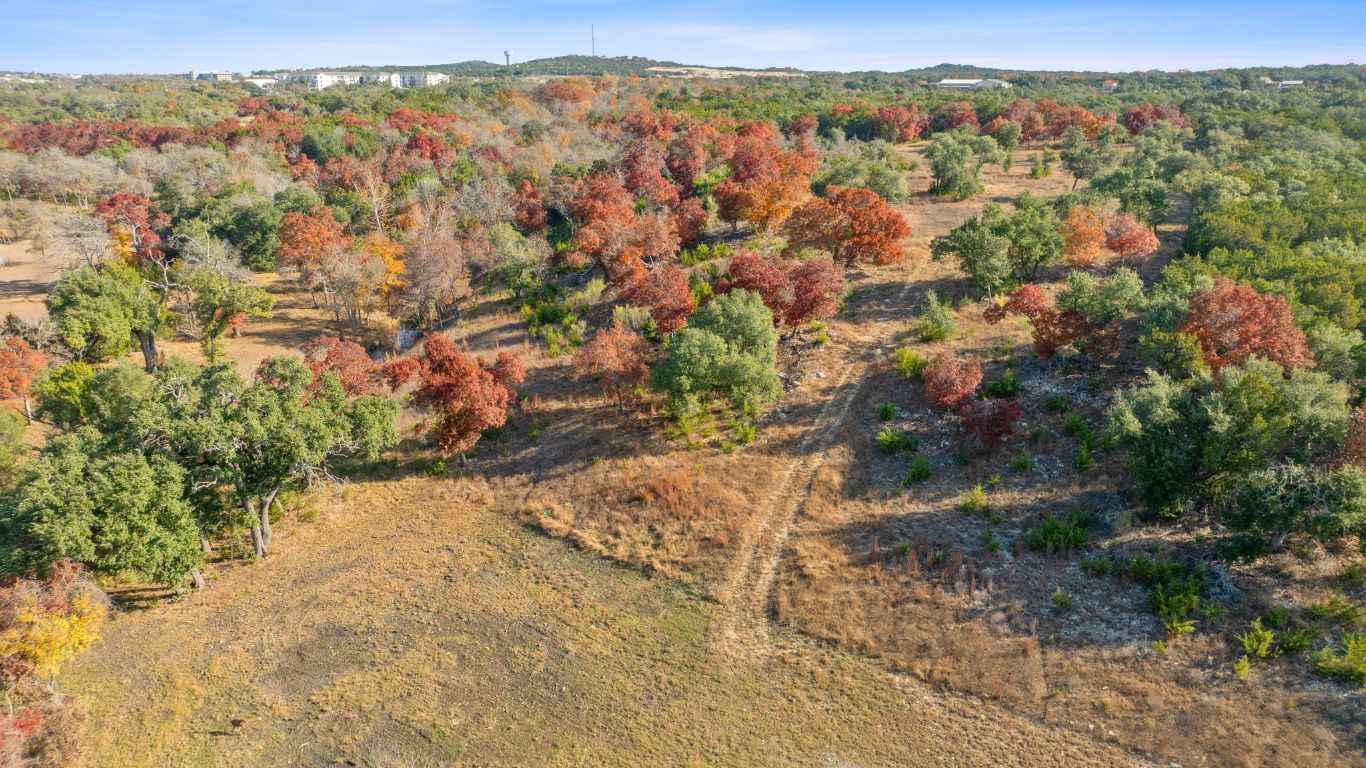 801 Needham Road Dripping Springs, TX 78620 - Photo 12 of 36 Aerial view of property's location featuring a heavily wooded area