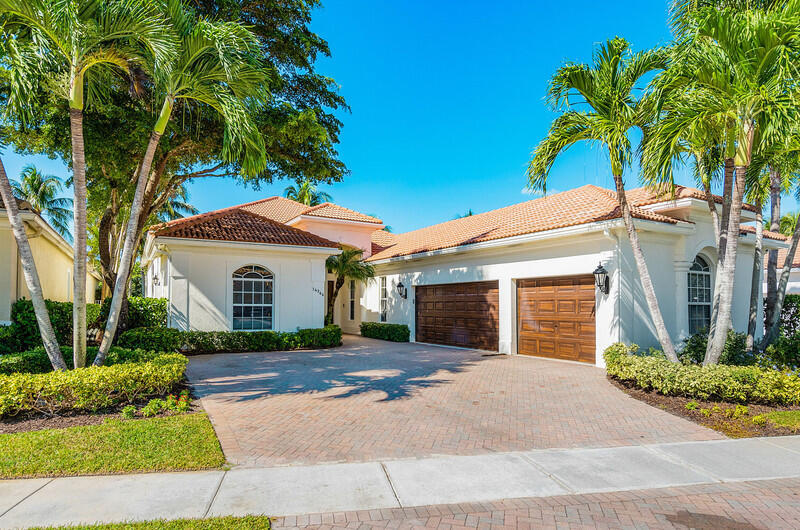 14364 Stroller Way Wellington, FL 33414 - Photo 1 of 47 a front view of a house with a yard and potted plants
