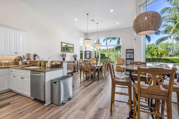 a view of a dining room with furniture a chandelier and wooden floor