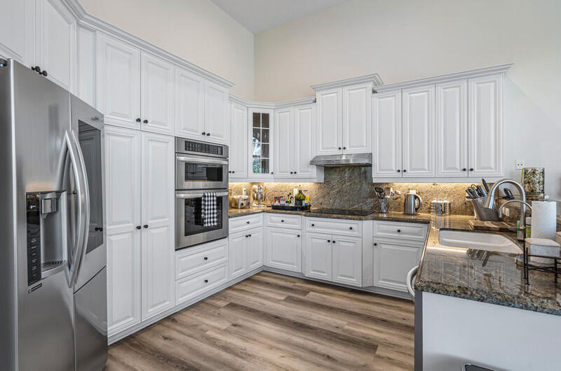 14364 Stroller Way Wellington, FL 33414 - Photo 14 of 47 a kitchen with granite countertop a refrigerator stove and sink