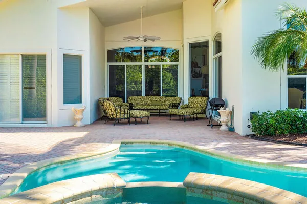 an aerial view of residential houses with outdoor space and swimming pool