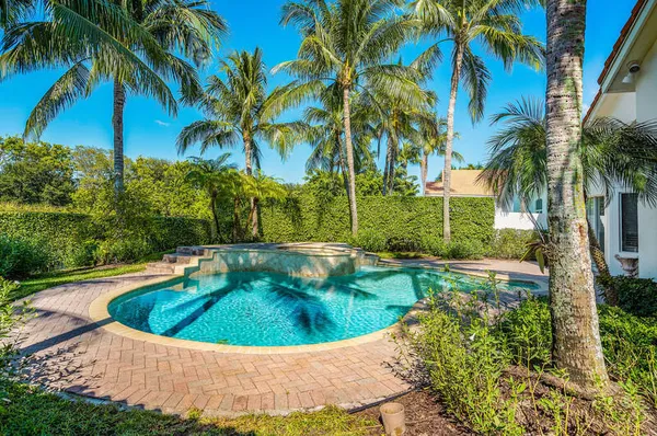 an aerial view of residential houses with outdoor space and swimming pool