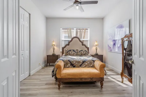 a bedroom with a bed and a chandelier