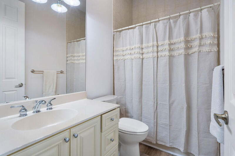 14364 Stroller Way Wellington, FL 33414 - Photo 31 of 47 a bathroom with a sink a toilet and shower curtain