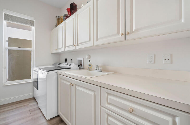 14364 Stroller Way Wellington, FL 33414 - Photo 32 of 47 a kitchen with white cabinets and sink
