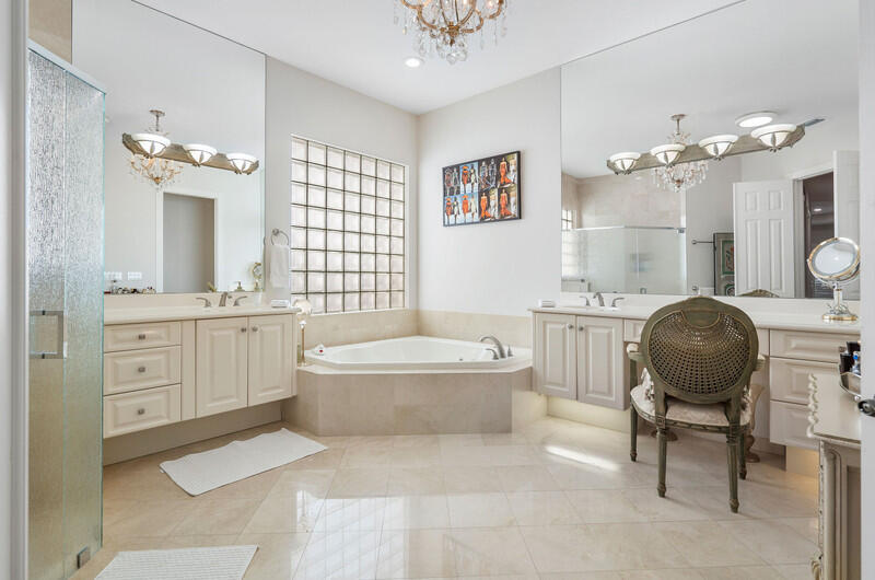 14364 Stroller Way Wellington, FL 33414 - Photo 33 of 47 a bathroom with a double vanity sink a toilet a mirror and bathtub