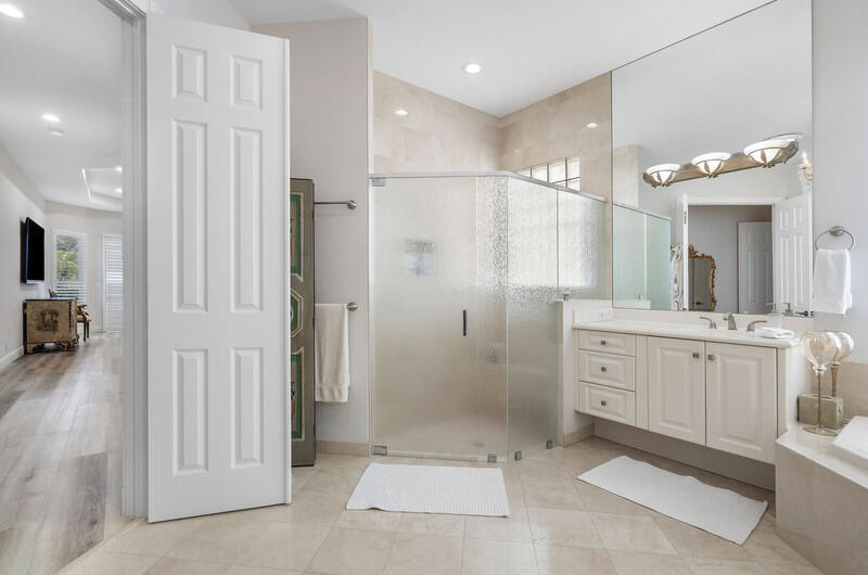 14364 Stroller Way Wellington, FL 33414 - Photo 36 of 47 a bathroom with a shower sink and mirror