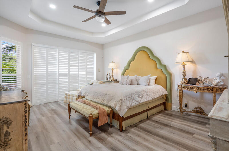 14364 Stroller Way Wellington, FL 33414 - Photo 39 of 47 a bed room with a bed and a chandelier