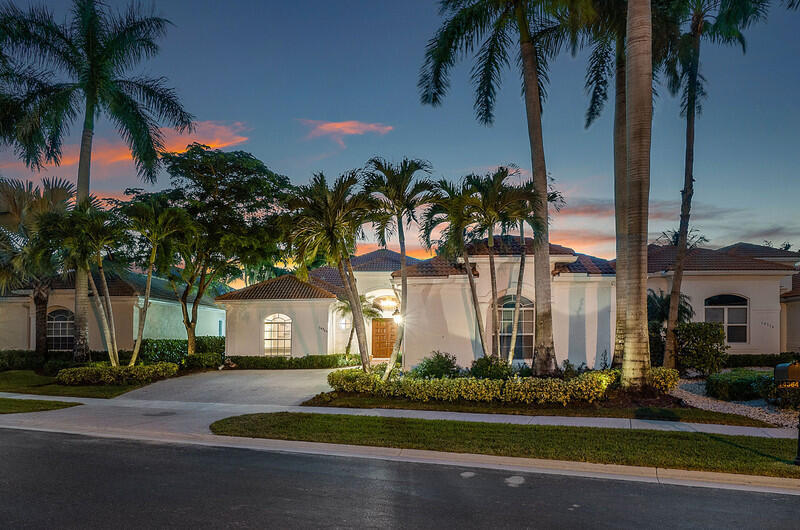 14364 Stroller Way Wellington, FL 33414 - Photo 40 of 47 front view of house with a yard and palm trees