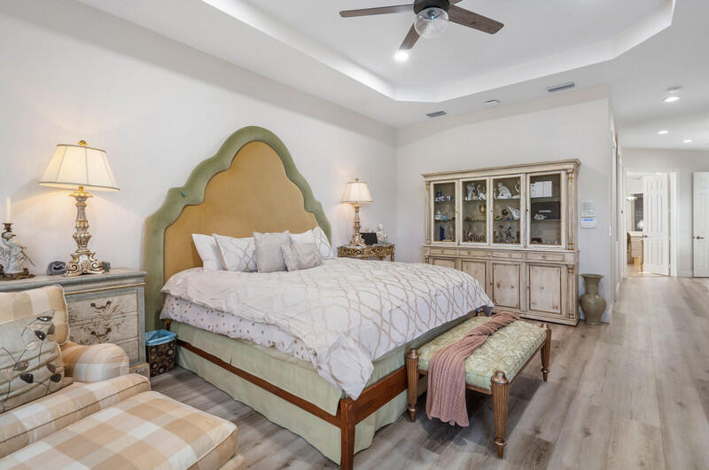 14364 Stroller Way Wellington, FL 33414 - Photo 42 of 47 a bedroom with a bed and a chandelier