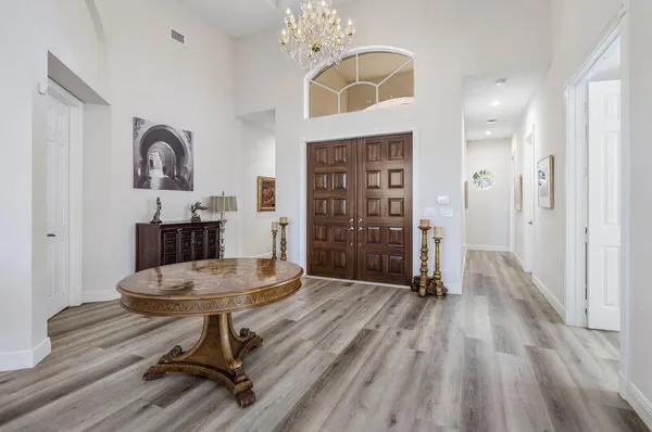 a view of a room with gym equipment and wooden floor