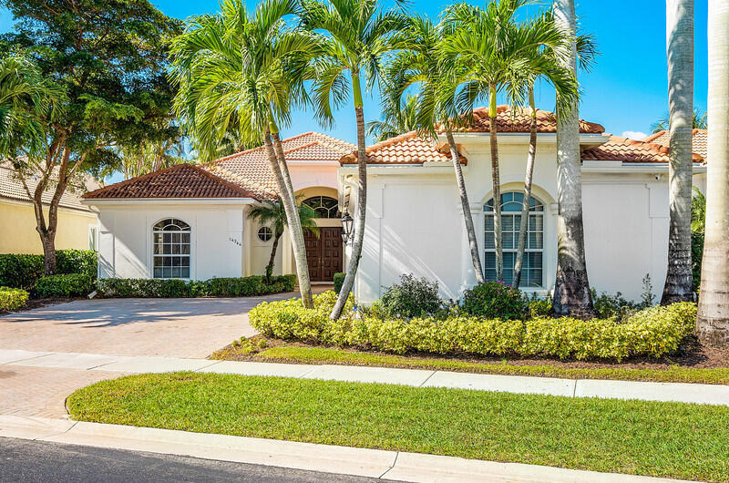 14364 Stroller Way Wellington, FL 33414 - Photo 6 of 47 a front view of a house with a yard and garage