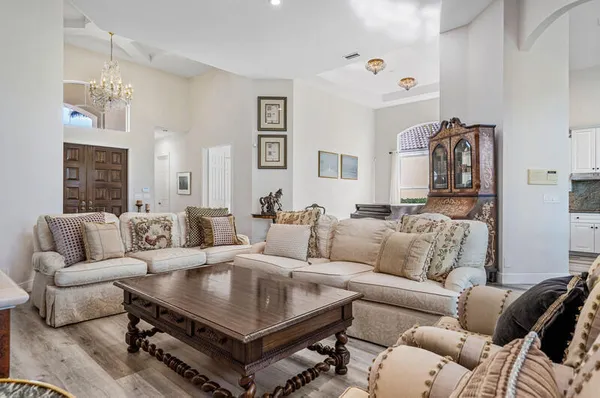 a open dining room with stainless steel appliances granite countertop furniture wooden floor and a kitchen view