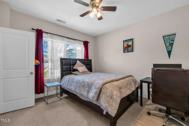 a bedroom with a bed and a chandelier