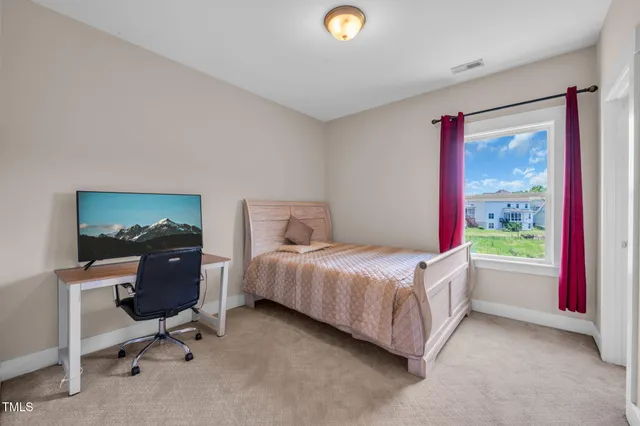 a bedroom with a bed and a dresser