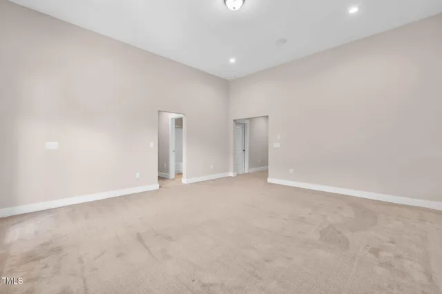 a view of a house with a big yard and potted plants