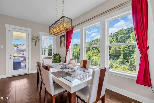a living room with furniture a fireplace and a chandelier