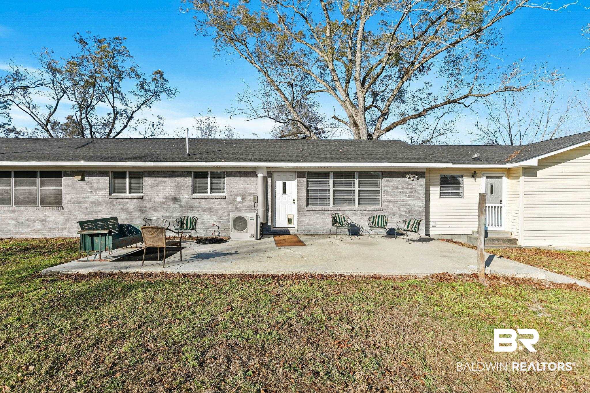 21267 Loop Road Andalusia, AL 36421 - Photo 55 of 72 Back of house featuring a patio, a lawn, and entry steps