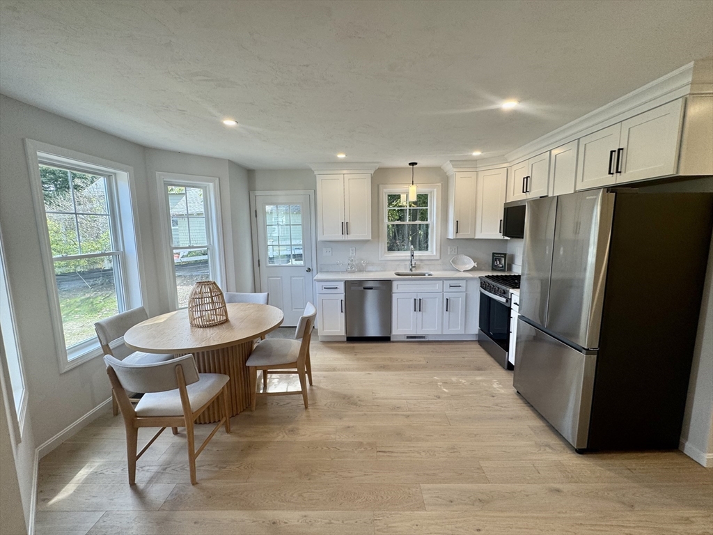 19 Ambrose Way, Unit 19 Shirley, MA 01464 - Photo 4 of 21 a kitchen with stainless steel appliances granite countertop a refrigerator and a stove top oven