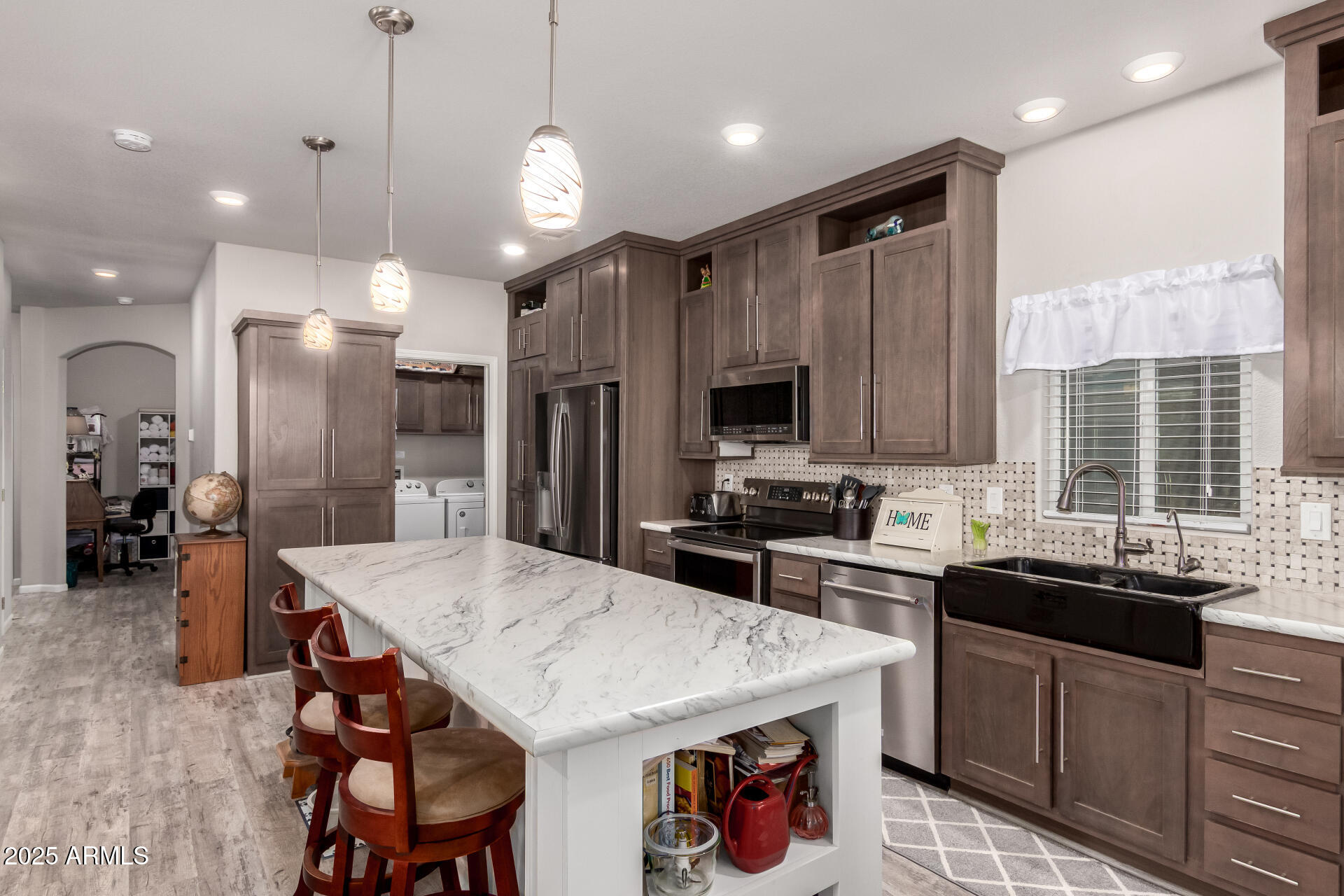 2929 East Main Street, Unit 160 Mesa, AZ 85213 - Photo 3 of 29 a kitchen with stainless steel appliances kitchen island granite countertop a sink a stove a refrigerator and island with wooden floor