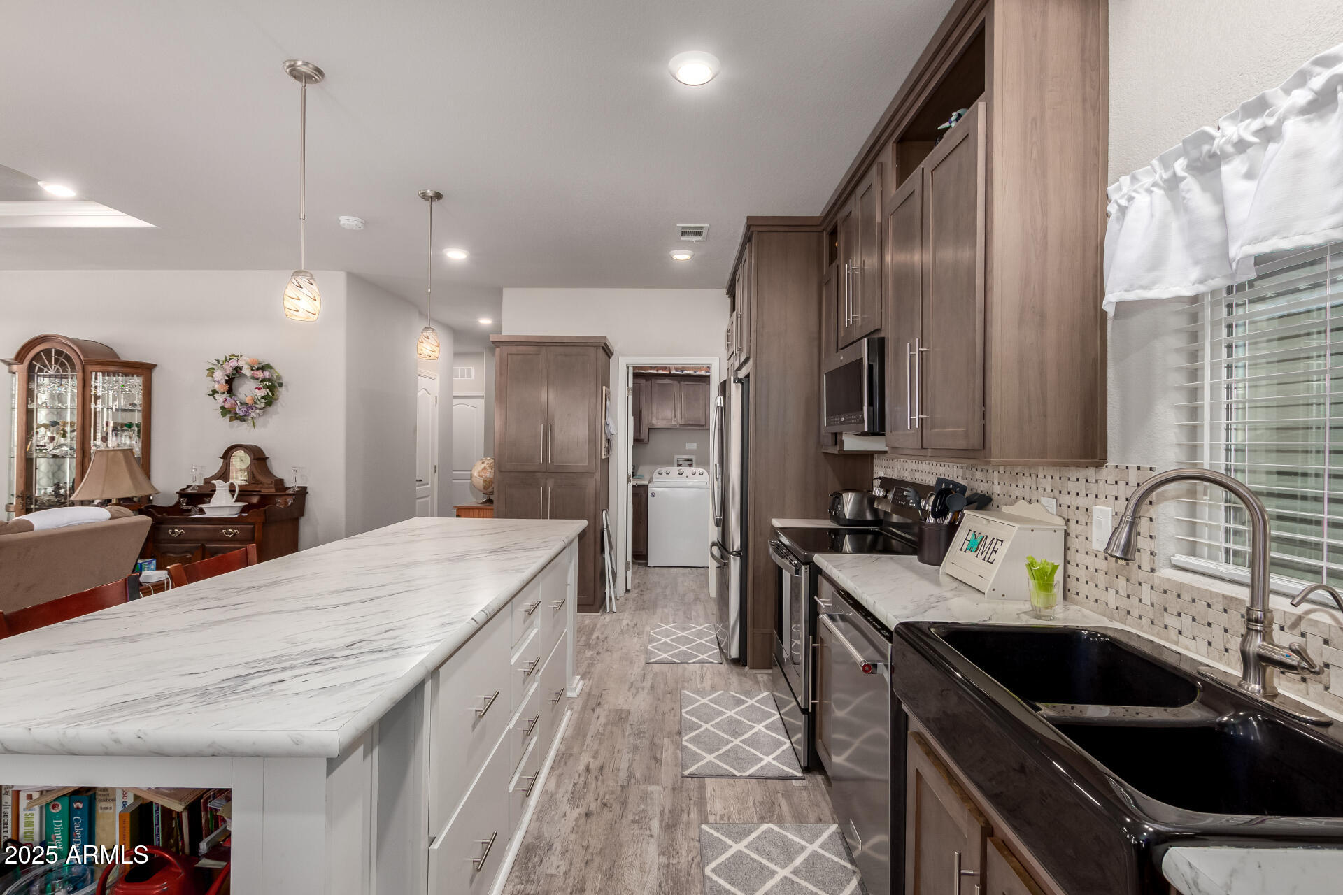 2929 East Main Street, Unit 160 Mesa, AZ 85213 - Photo 5 of 29 a kitchen with kitchen island granite countertop a sink stainless steel appliances and window