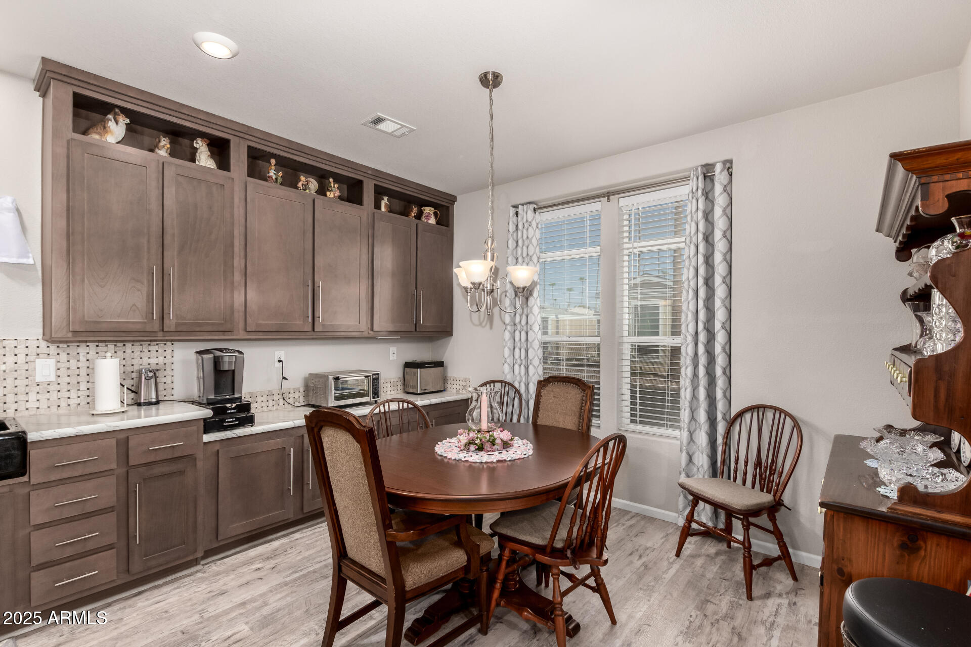 2929 East Main Street, Unit 160 Mesa, AZ 85213 - Photo 7 of 29 a kitchen with a table chairs stove and microwave