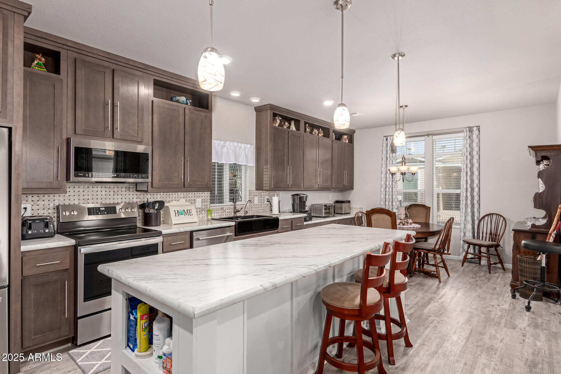2929 East Main Street, Unit 160 Mesa, AZ 85213 - Photo 8 of 29 a kitchen with granite countertop a stove a sink a dining table and chairs