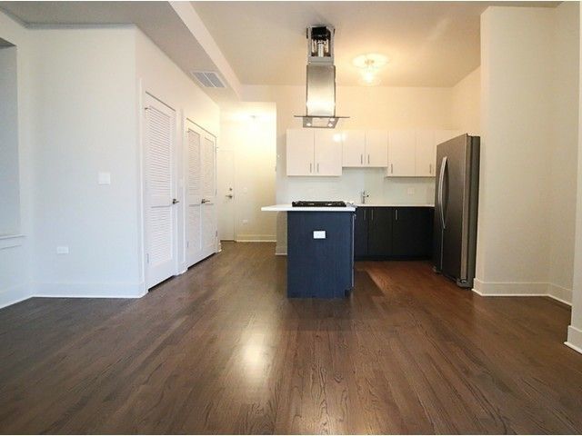 1418 West Addison Street, Unit 101 Chicago, IL 60613 - Photo 3 of 5 a view of kitchen and wooden floor