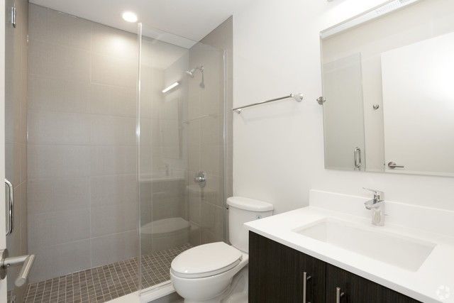 1418 West Addison Street, Unit 101 Chicago, IL 60613 - Photo 4 of 5 a bathroom with a sink a toilet and shower