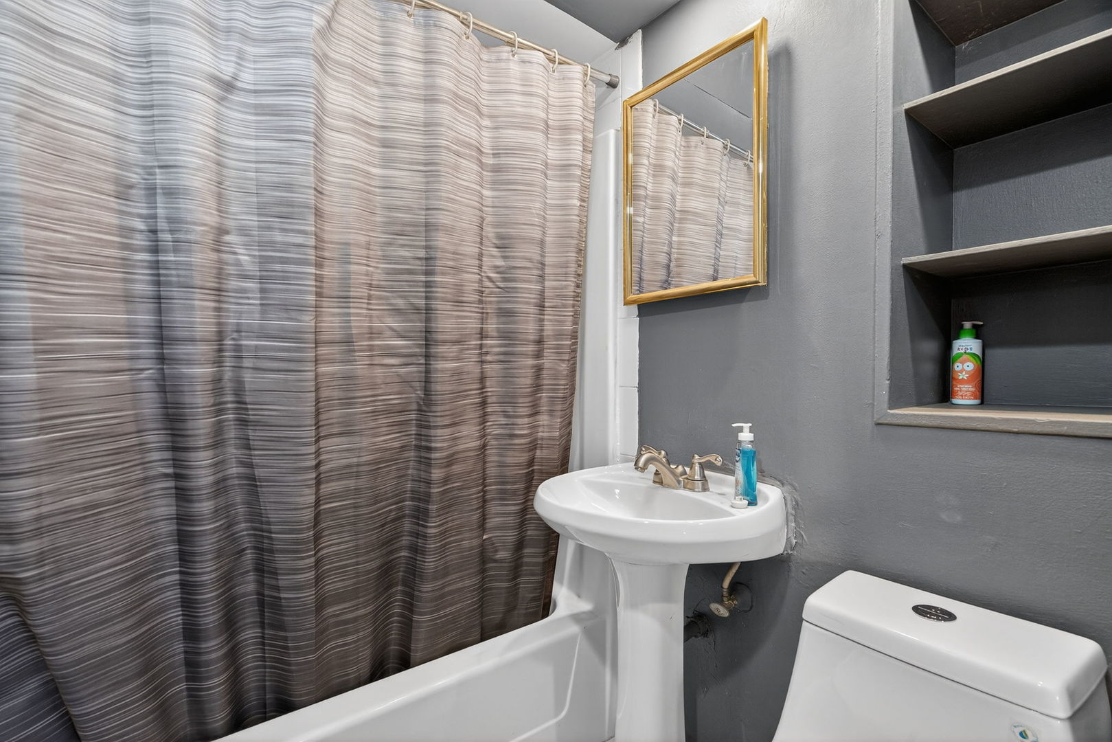 1225 Clara Avenue Joliet, IL 60435 - Photo 14 of 24 a bathroom with a sink a toilet and mirror