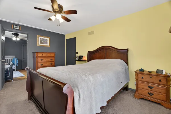a bedroom with a bed and a dresser