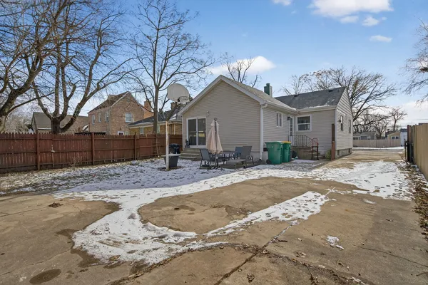 a view of a house with a yard covered in snow