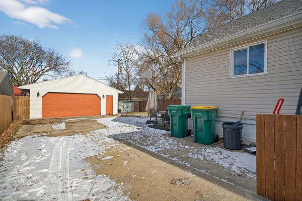 a backyard of a house with barbeque oven and outdoor seating