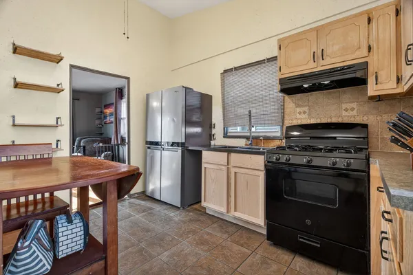 a kitchen with stainless steel appliances granite countertop a stove a refrigerator and a microwave